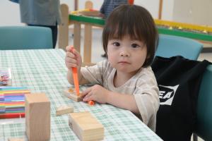 木工体験で木に絵を描いている子ども
